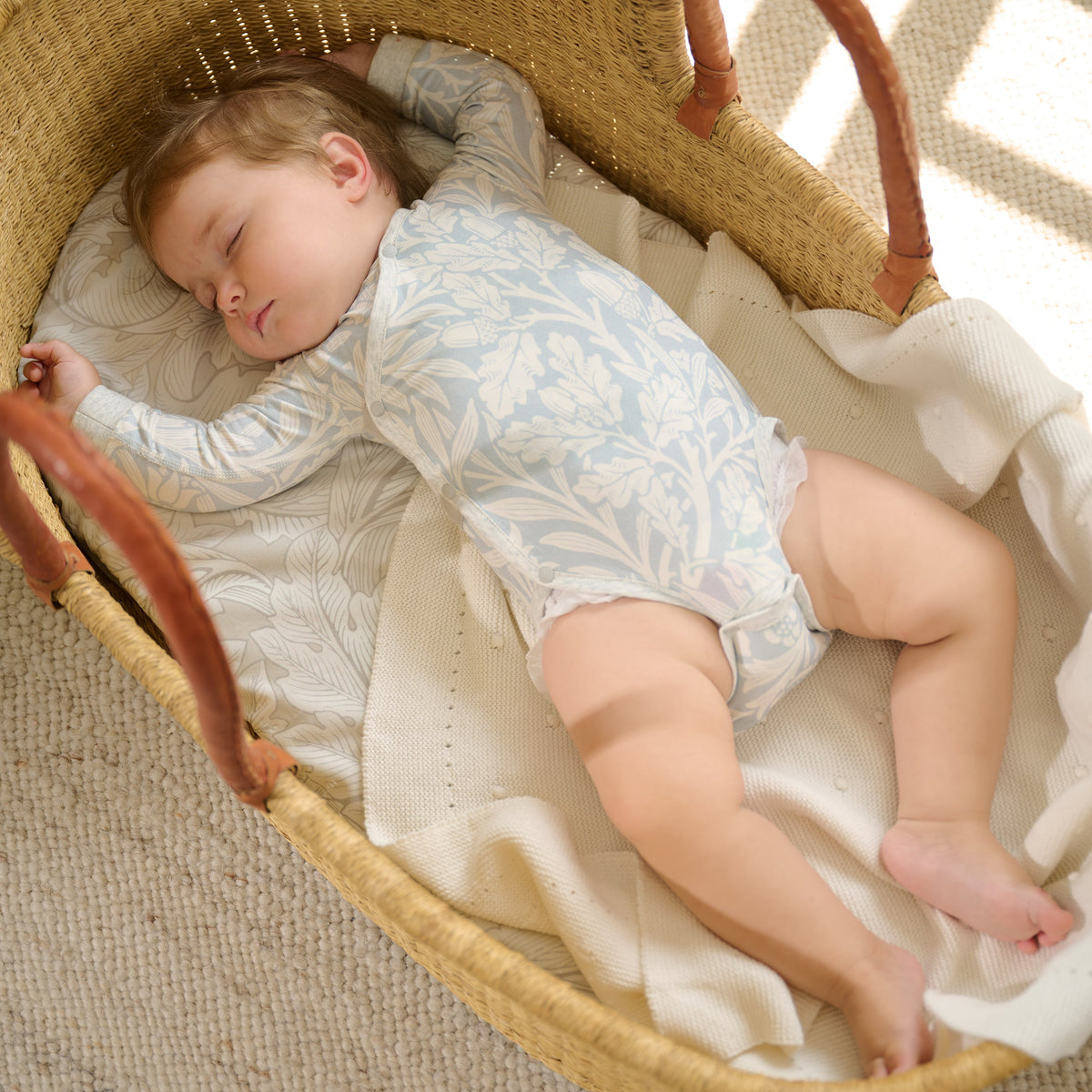 Baby wearing Acorn Slate Blue kimono onesie, lifestyle