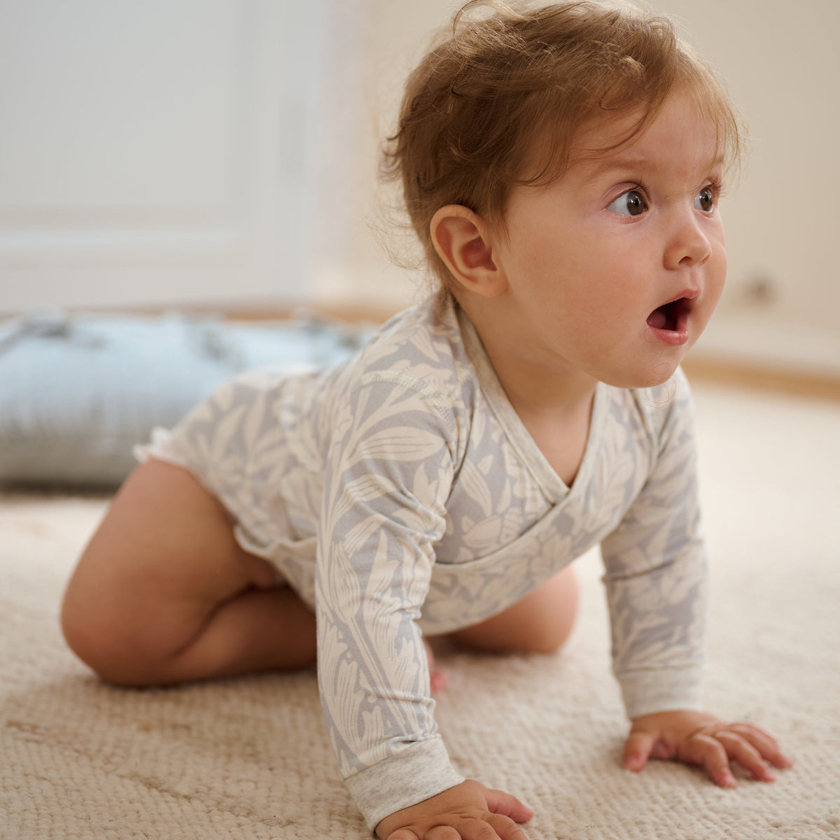 Close-up of baby wearing Acorn Slate Blue kimono onesie